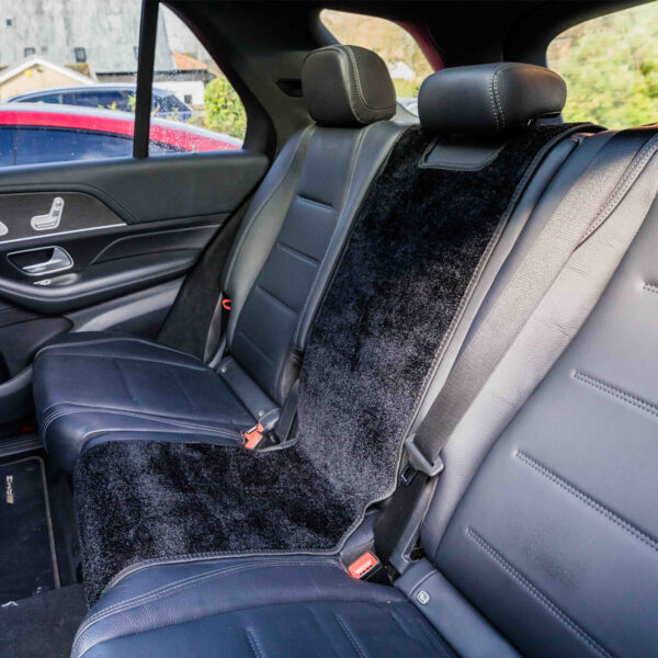 black dog car seat cover fitted in the back of a car